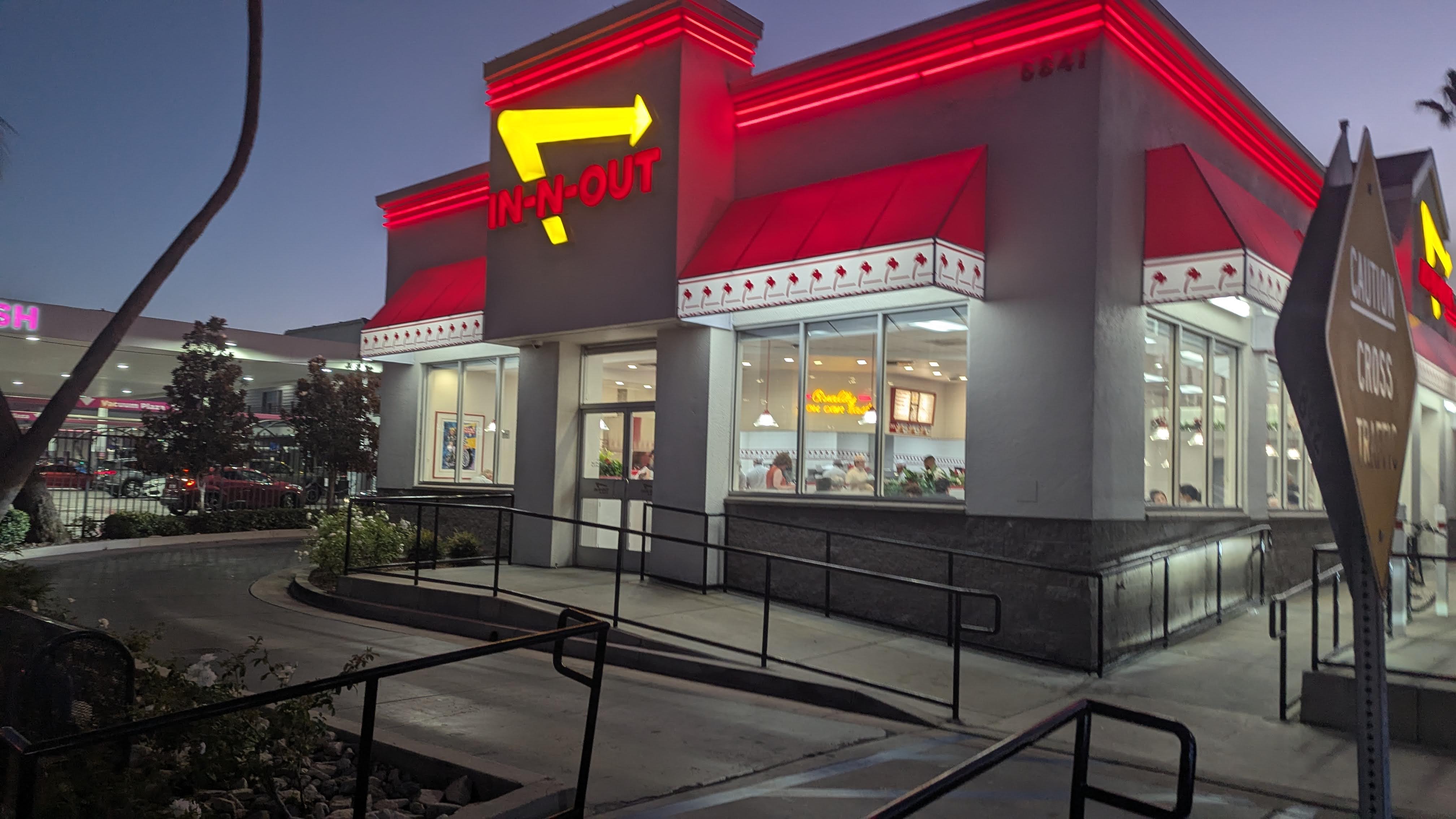 The iconic In-N-Out Burger restaurant with its glowing yellow arrow sign